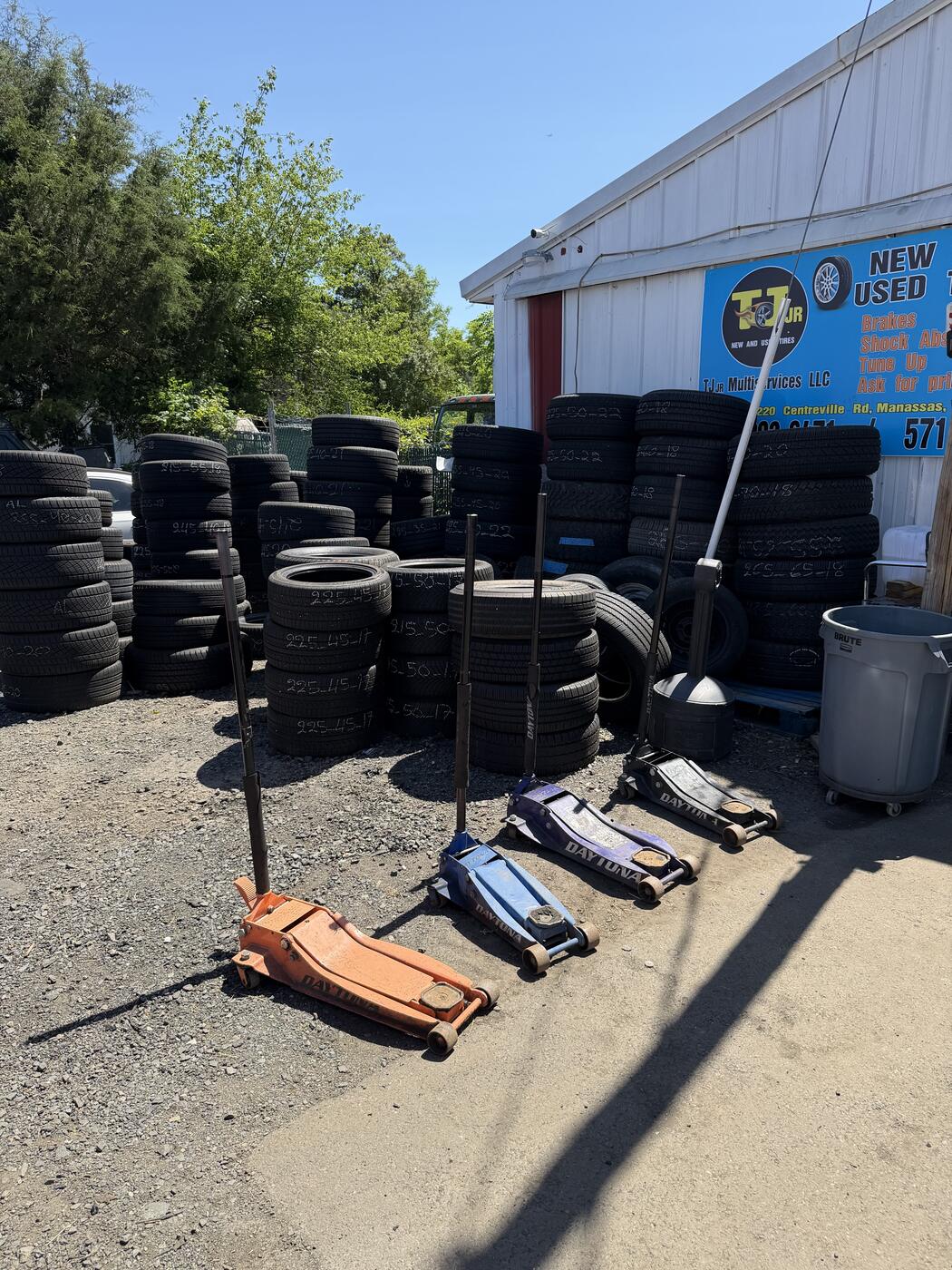 Stacks of tires and Daytona floor jacks inside the TJ Jr shop